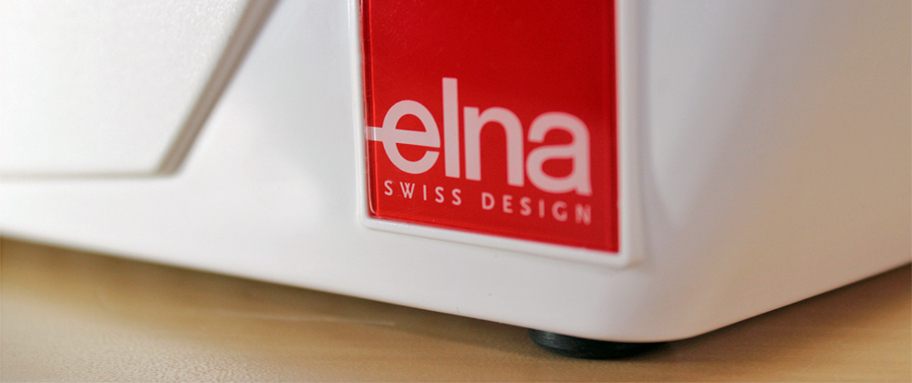 Komputerowa maszyna do szycia Elna 550 eX, 560 eX, 570 eX - recenzja serii eXperience - logo swiss desing